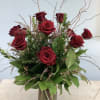 Premium, deep red roses with curly willow, lush green foliage and filler