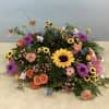 Bright mixed blooms in yellow, pink, orange, and purple-sunflower-centered, with roses, daisies