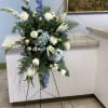 White and blue standing spray of roses, hydrangeas, lilies and delphinium with