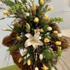Yellow and white tulips with a central white lily, airy green accents