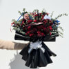 A Chucky and his bride-themed bouquet. Designed with burgundy dahlias and deep