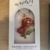 Red floral enamel keychain in a white retail box
