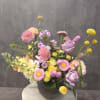 Mixed pastel flower arrangement in a dark vase