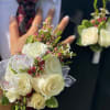 White rose bouquet and matching boutonniere on a suit jacket