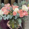 Bouquet of pink and white roses in a clear glass vase