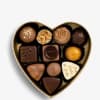 Heart-shaped box of assorted chocolates on a white background