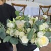 White rose bouquet with eucalyptus in a black wrap
