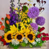 Colorful mixed flower arrangement with sunflowers, roses, tulips, and purple alliums