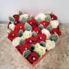Heart-shaped box of red and white roses with folded dollar bills