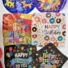 Assorted birthday balloons with colorful printed designs and messages