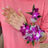 Woman wearing a purple orchid corsage and matching wristlet