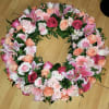Heart-shaped floral wreath with pink and peach roses and lilies