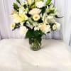 White floral arrangement in a clear glass vase