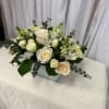 White rose bouquet with eucalyptus in a square vase