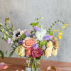 A petite arrangement in a spring color palette, designer's choice. 