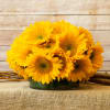 Bouquet of yellow sunflowers in a low glass vase