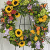 Heart-shaped floral wreath with sunflowers, roses, and butterflies