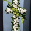 White and green floral cross arrangement on a stand