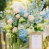 Pastel floral arrangement with blue and pink blooms in a vase