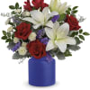 Bouquet of red roses and white lilies in a blue vase