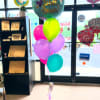 Cluster of colorful birthday and get well balloons in a store entrance