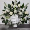White rose and chrysanthemum arrangement with a large white bow