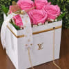 Vibrant roses, delicate baby's breath, lush greenery, and a gold butterfly accented
