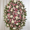 Standing spray of pink and white flowers with lilies and roses