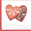 Heart-shaped Valentine card with a pink bow and small paper quilled hearts