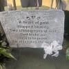Memorial plaque on an easel with a white ribbon bow