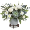 White roses and daisies arranged in a gray pot with a succulent centerpiece