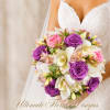 Bride holding a bouquet of purple roses and white orchids