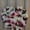 The precious heart is a solid heart arrangement with white hydrangeas, freesias