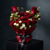 Red roses and white spray flowers in red wrap with a birthday ribbon