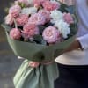 Bouquet of pink roses and white carnations wrapped in green paper