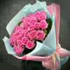 Bouquet of pink roses wrapped in pastel blue and pink paper