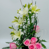 Romantic pink roses cascade downward from a compact base, interwoven with white
