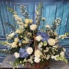 Large basket arrangement of white and blue flowers