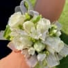 White rose corsage with ribbon on a wrist