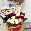 Gift set with red and white roses in a red box, two plush dolls, a bottle, and a clear anniversary balloon.