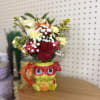 Red and cream roses in a novelty ceramic pot
