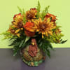 Autumn bouquet with orange roses and yellow chrysanthemums in a turkey vase