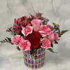 Pink and red mixed bouquet in a colorful mosaic vase