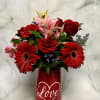 Red and pink mixed bouquet in a red vase with a heart and the word Love