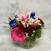 Mixed bouquet in a glass vase with a birthday tag