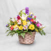 Mixed flower basket with daisies, lilies, and roses in a woven basket