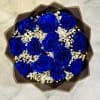 Bouquet of vivid blue roses with white baby's breath