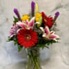 A bold orange gerbera takes center stage in this Summer Lovin' flower