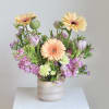 Enjoy a sophisticated arrangement in dreamy shades of mauve, taupe, and peach