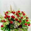 Basket arrangement of red roses with white filler flowers and greenery